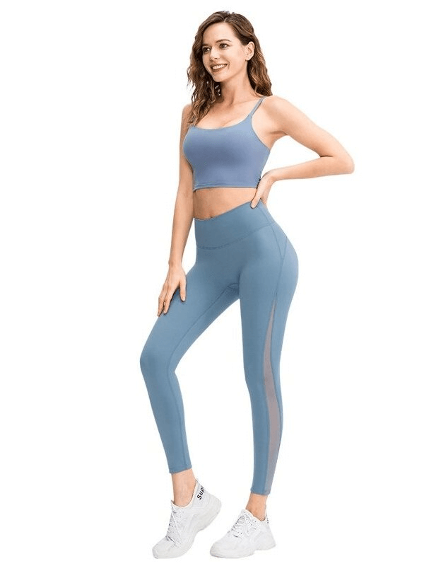 Woman wearing sporty seamless blue leggings with high waist and ankle-length design, ideal for yoga and active lifestyles.